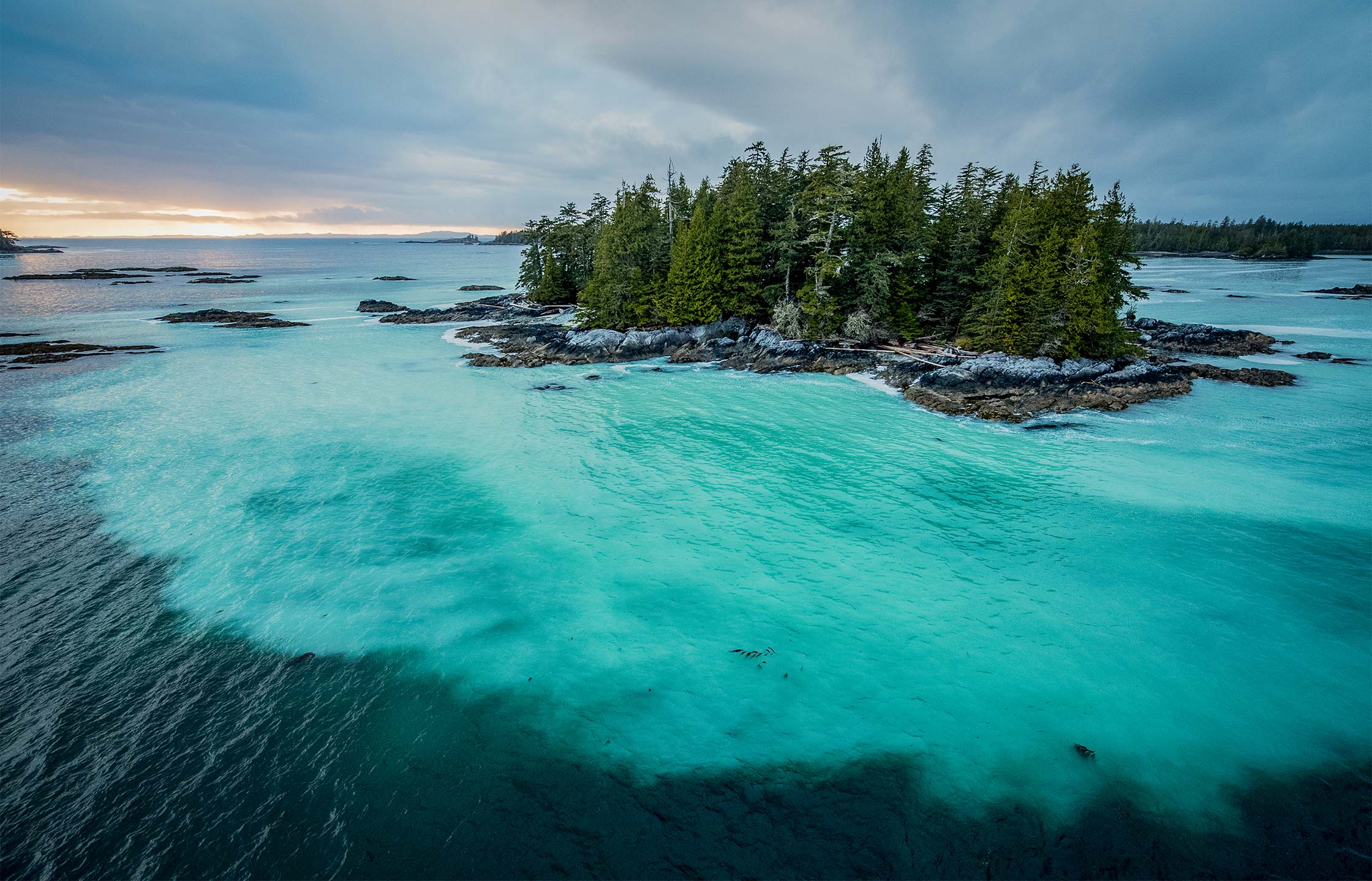 Aerial photo off the coast of a small island. The waters near the island are milky because of the herring spawning in them.