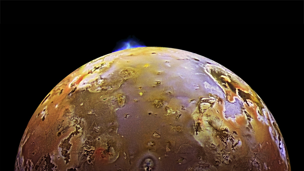 A yellow moon of Jupiter with a blue eruption.