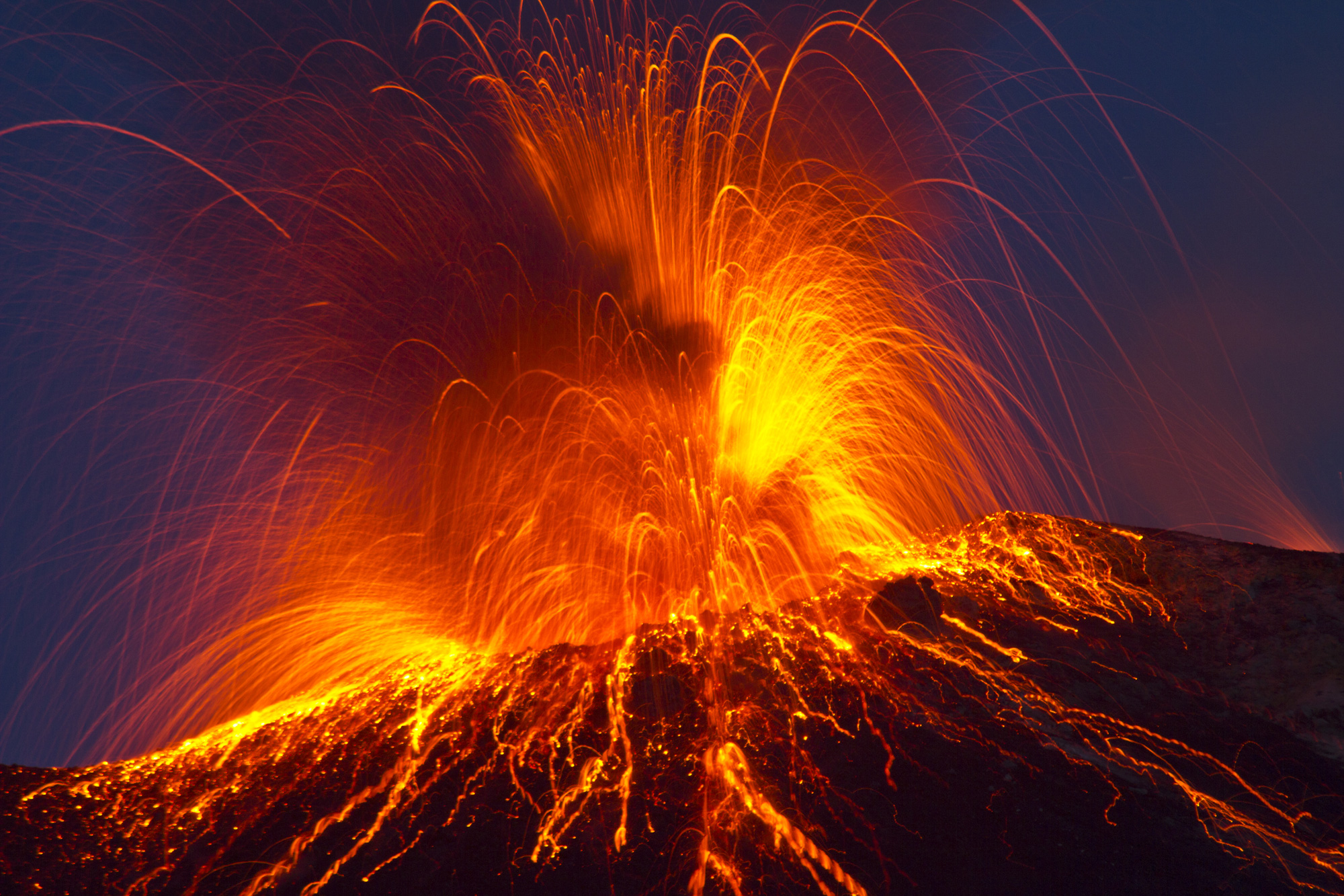 Lava coming out of a volcano at night.