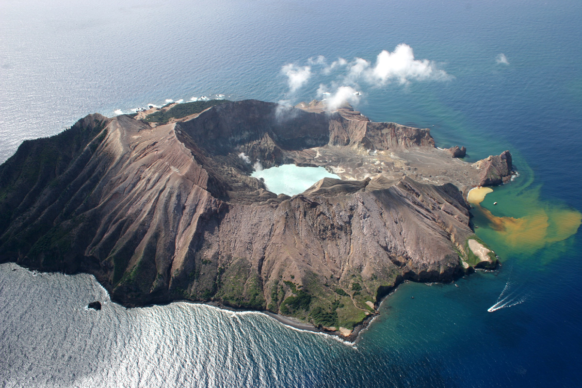 A small mountainous volcanic island poking out of the sea.