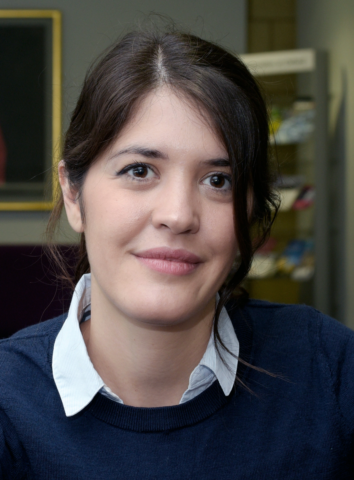 A smiling woman with brown hair.