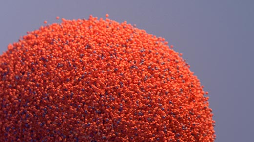 An orange ball decomposing into points and rematerializing as two balls, each the same size as the first.