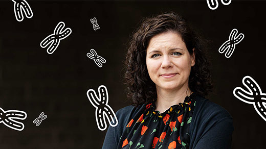 Photo of Karen Miga of the University of California, Santa Cruz, with a representation of chromosomes in the background.