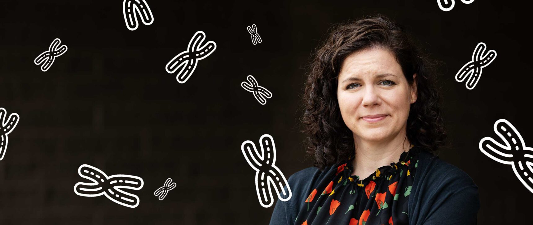 Photo of Karen Miga of the University of California, Santa Cruz, with a representation of chromosomes in the background.