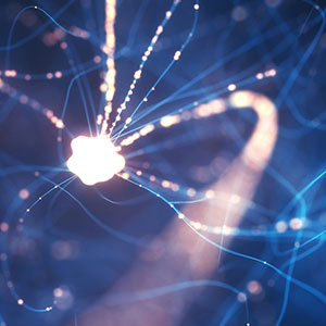 Illustration of a neuron lit up with electrical signals.