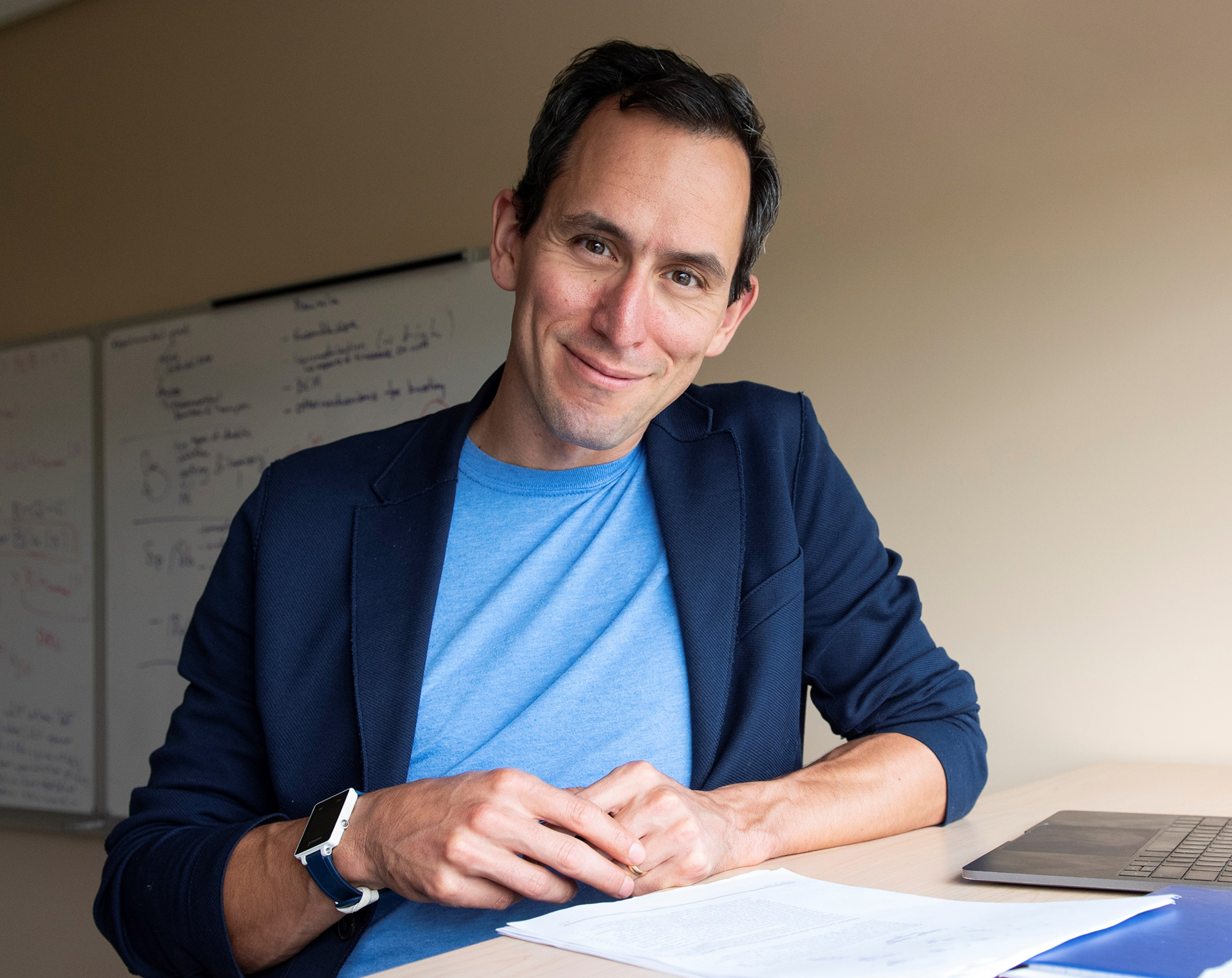 A portrait of Blake Richards in a green sweater against a white background; a portrait of Richard Naud in a blue shirt and blazer, at a desk.