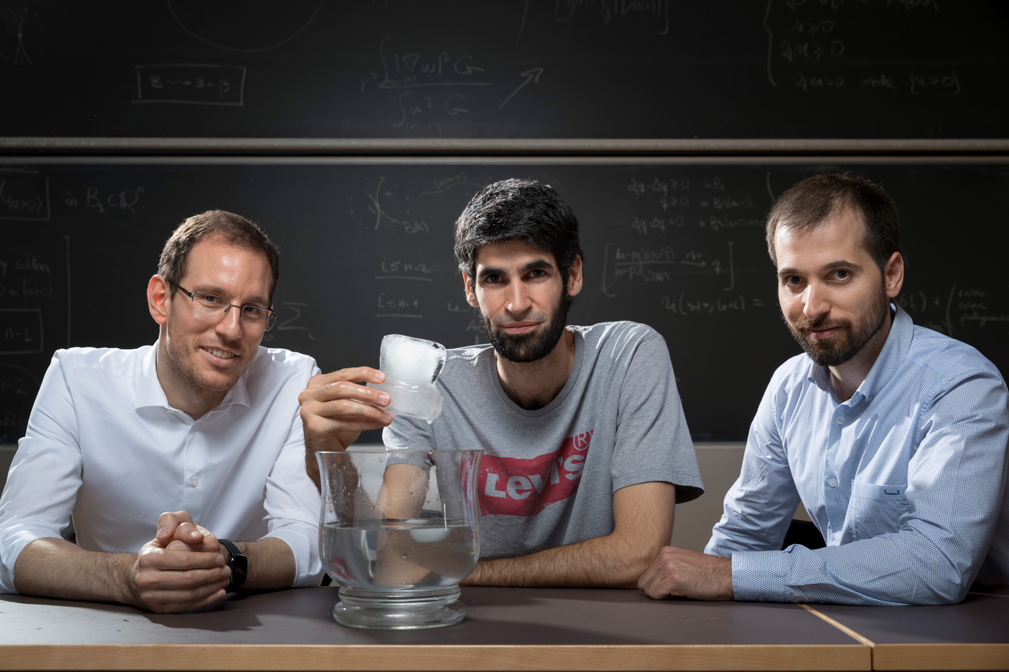 A photograph of mathematicians Alessio Figalli, Xavier Ros-Oton and Joaquim Serra.