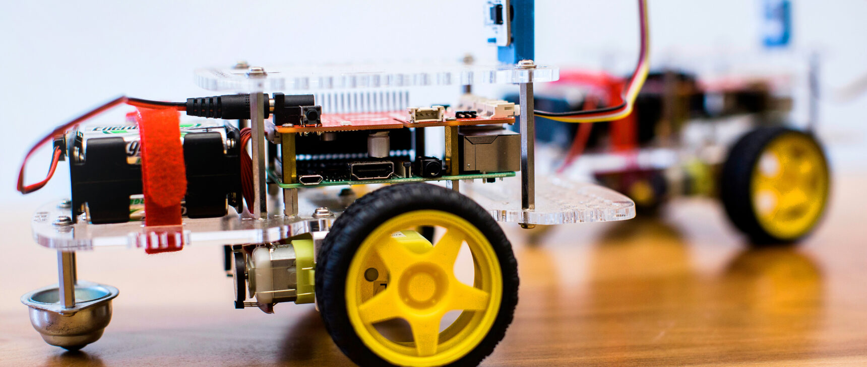 Closeup photo of an automated two-wheeled robot on a wooden table