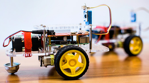 Closeup photo of an automated two-wheeled robot on a wooden table