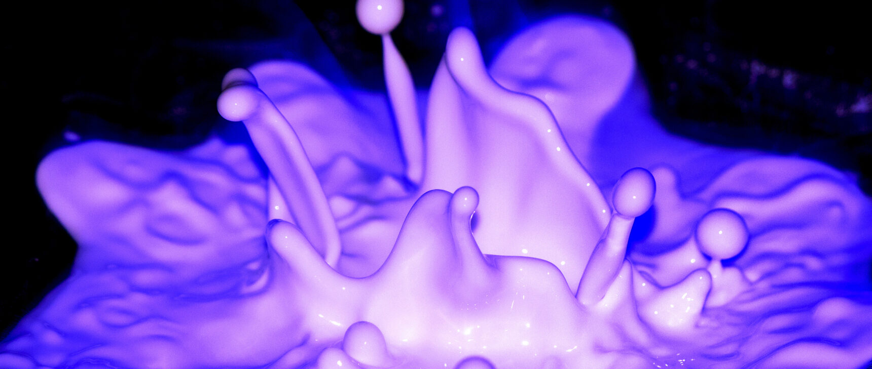 Fluorescent purple liquid splashes.