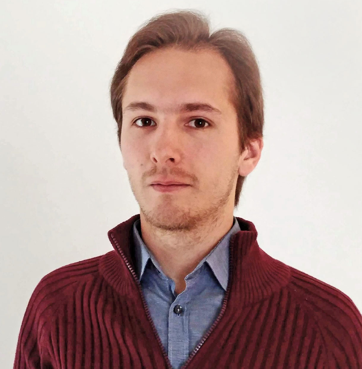 Photo of Alexey Dosovitskiy in a shirt and sweater against a white background