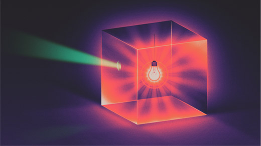 Illustration of a glass box illuminated inside by a red lightbulb. A ray of green light shoots out of the box.