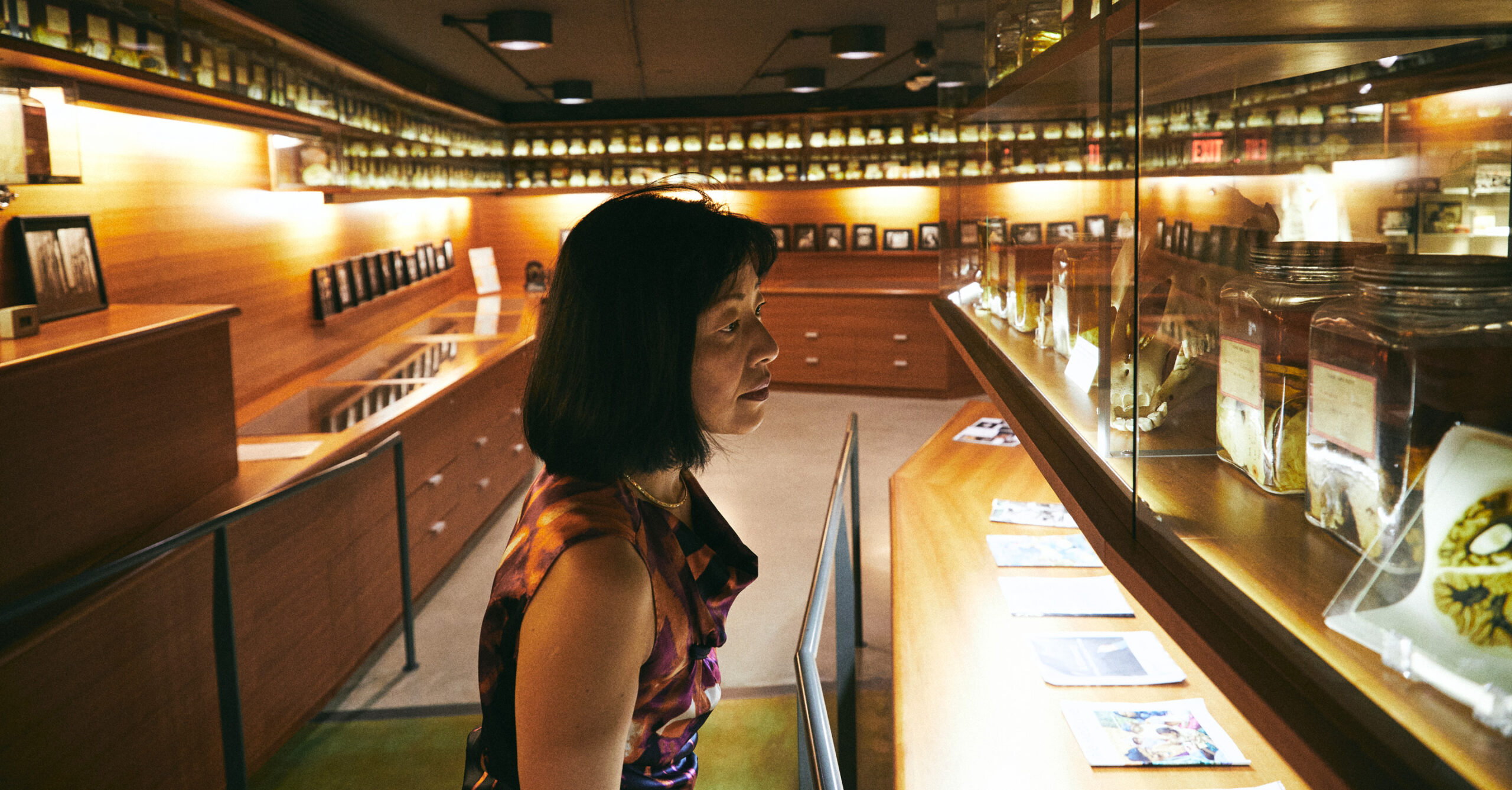 Iwasaki looks at exhibits on the shelves of a medical museum.