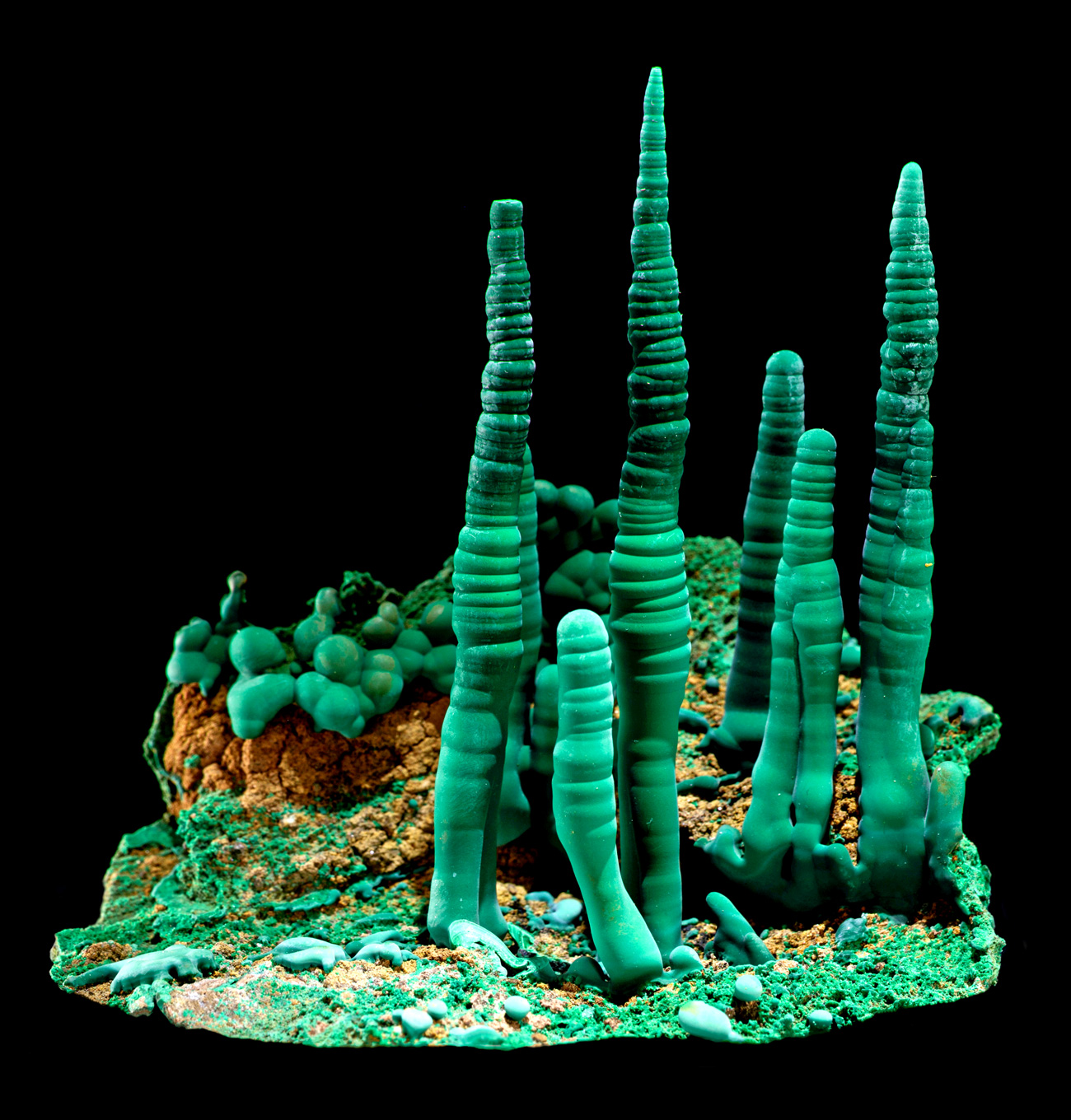 Close-up of a malachite formation against a black background.