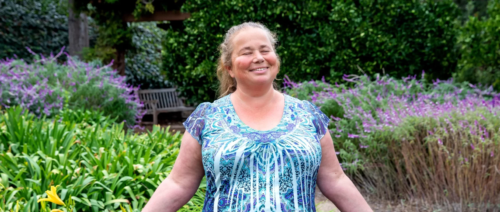 Svetlana Jitomirskaya in a blue shirt with her hands out.