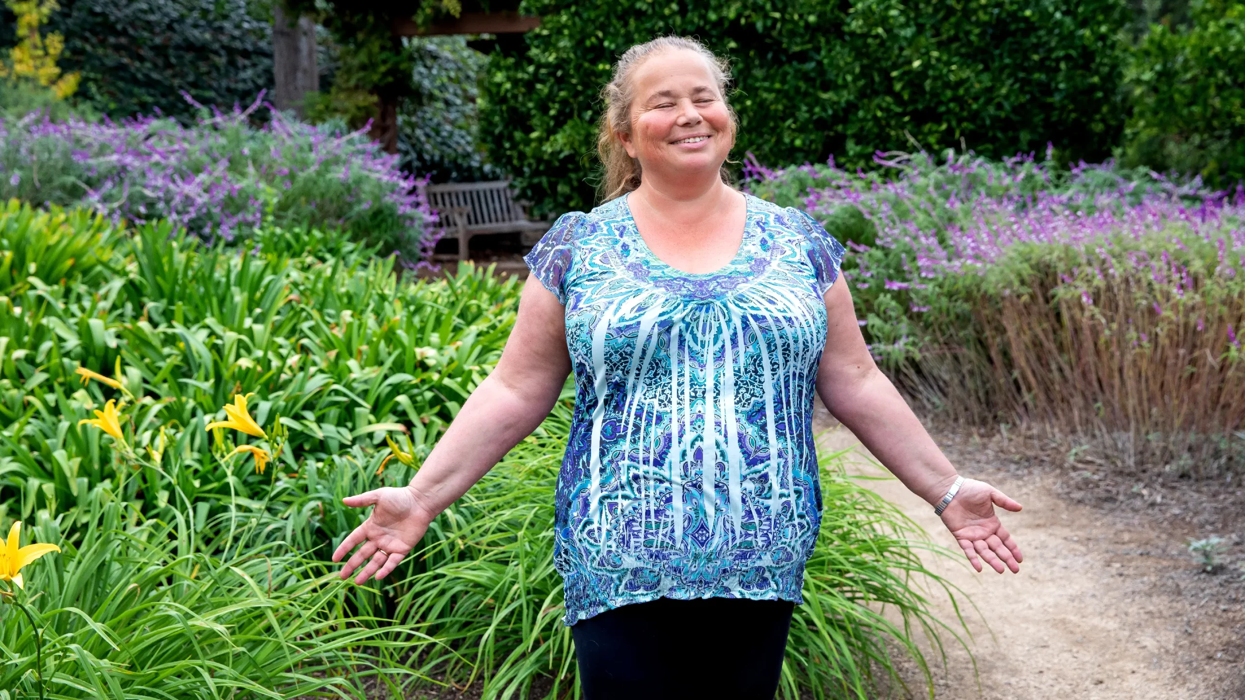 Svetlana Jitomirskaya in a blue shirt with her hands out.