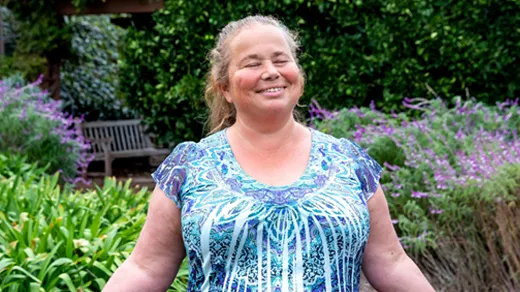 Svetlana Jitomirskaya in a blue shirt with her hands out.