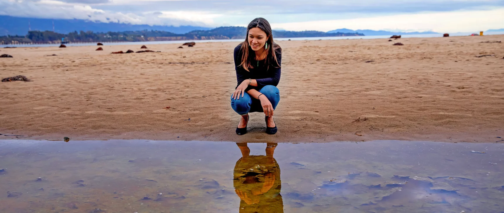 Holly Moeller walks along Campus Point Beach.