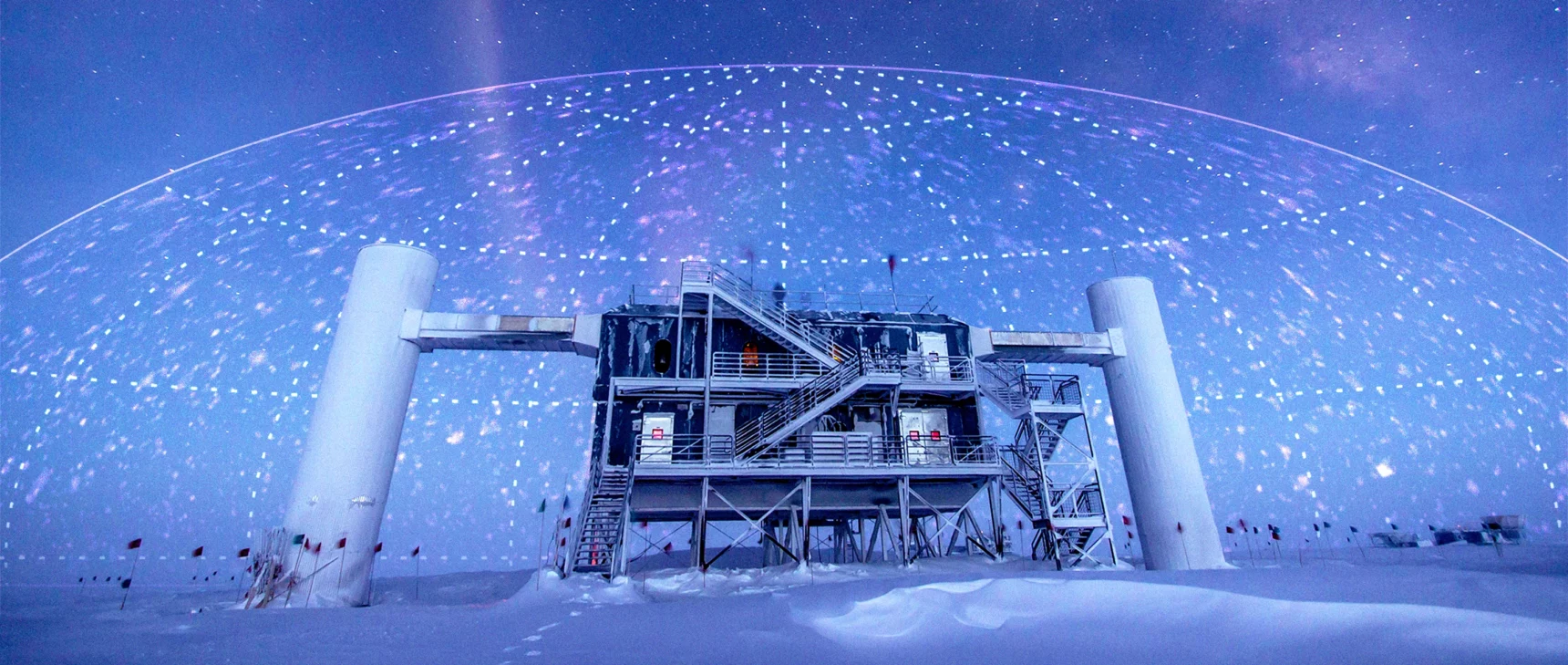 A photo illustration showing a research station in Antarctica with a map plotting neutrinos’ arrival directions imprinted on the sky.