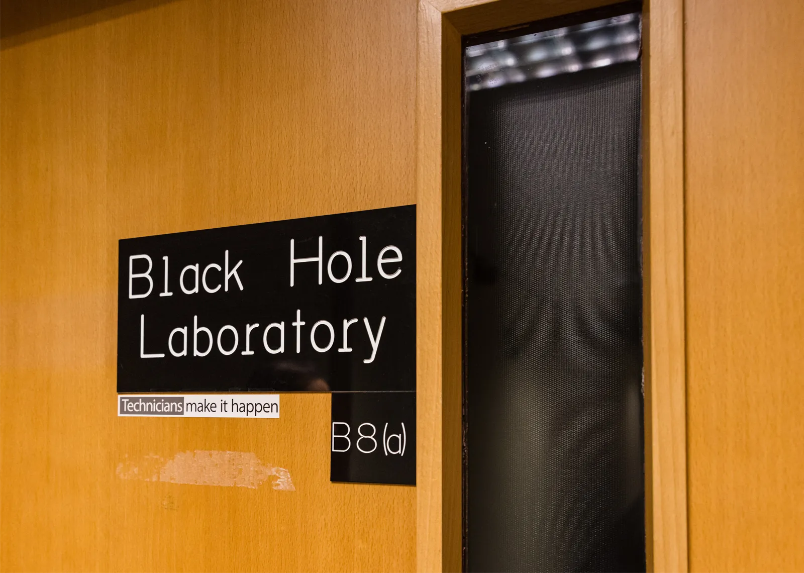 A door sign reads “Black Hole Laboratory.”