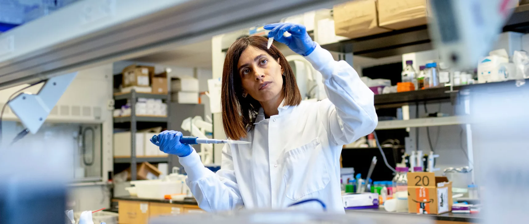 Nikta Fakhri looks at a test tube.