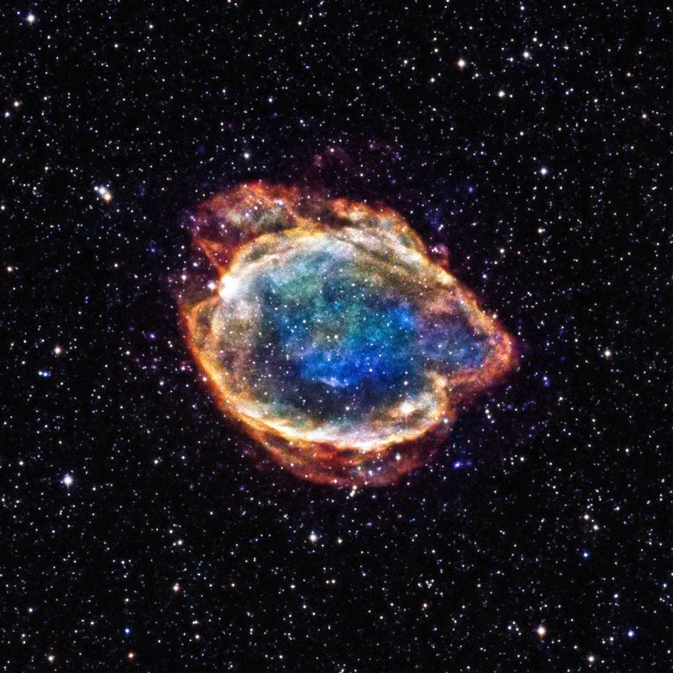 colorful supernova in front of a starry background (the edges are orange and as you move inward, the clouds become blue and green)