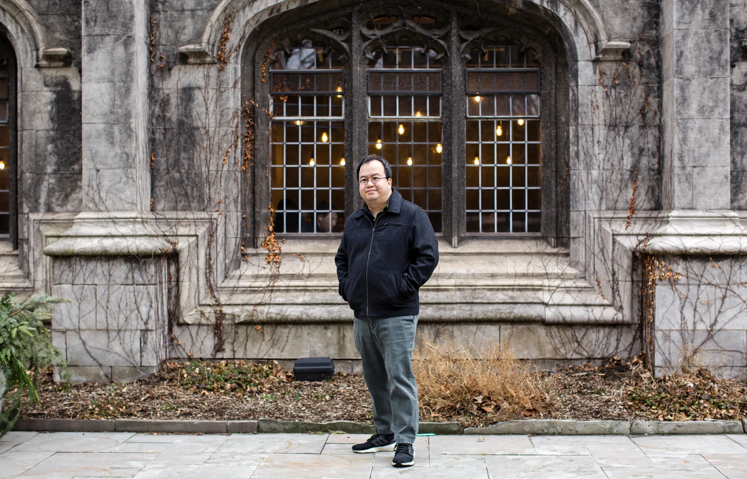 Lim standing in front of a building at the University of Chicago.