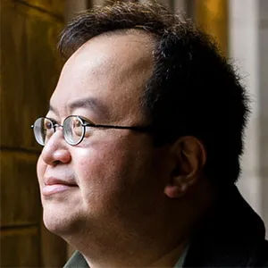 Mathematician Lek-Heng Lim standing near some columns at the University of Chicago.