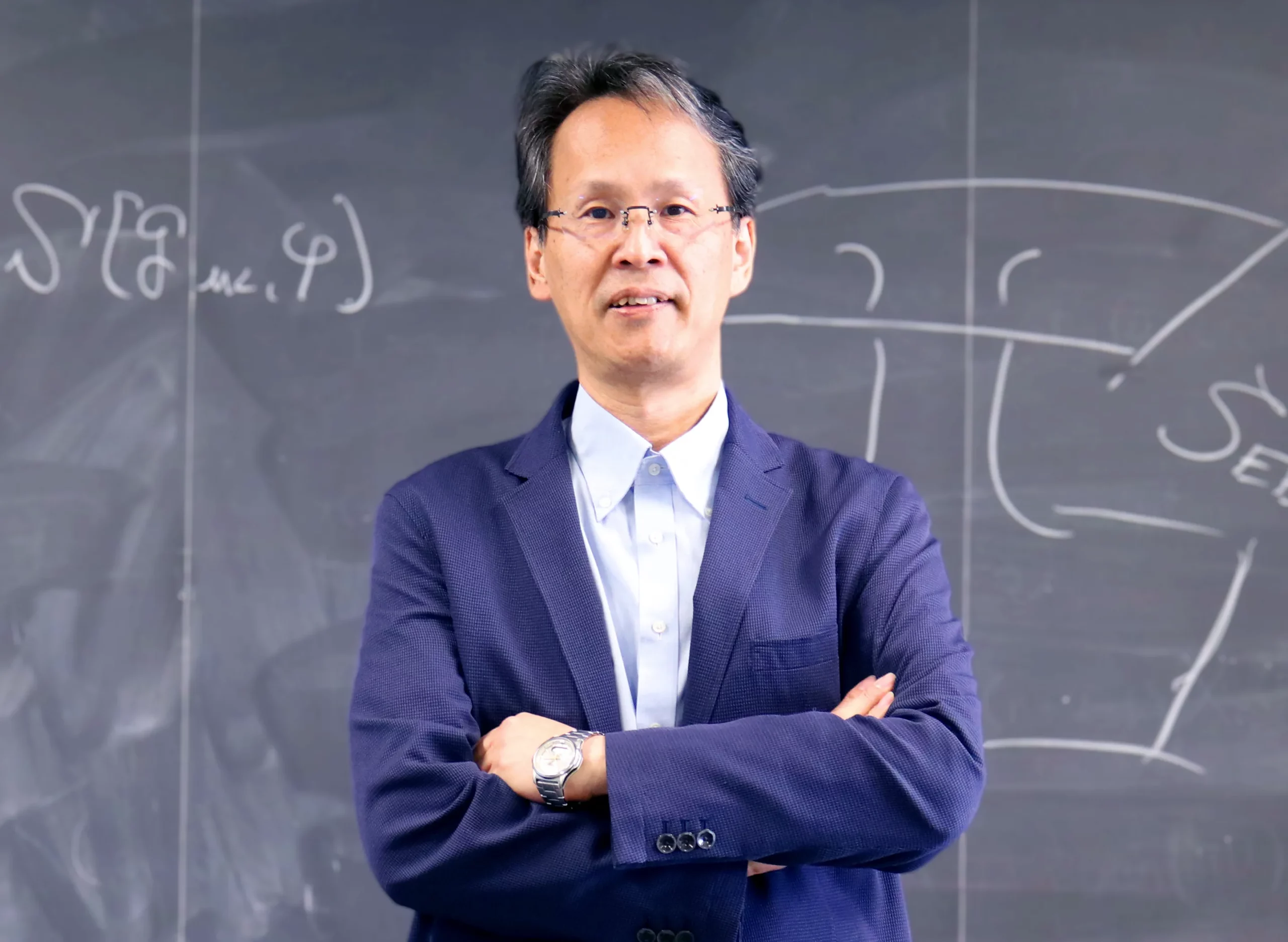 A man in front of a chalkboard.