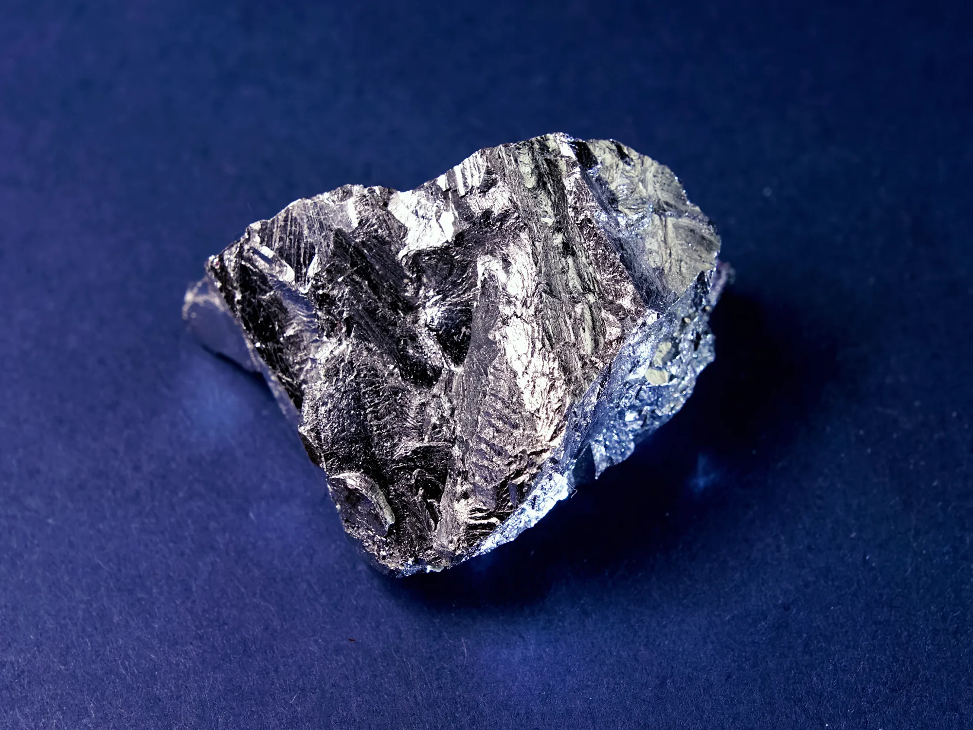 Photograph of shiny solid cubical piece of an element called lutetium.