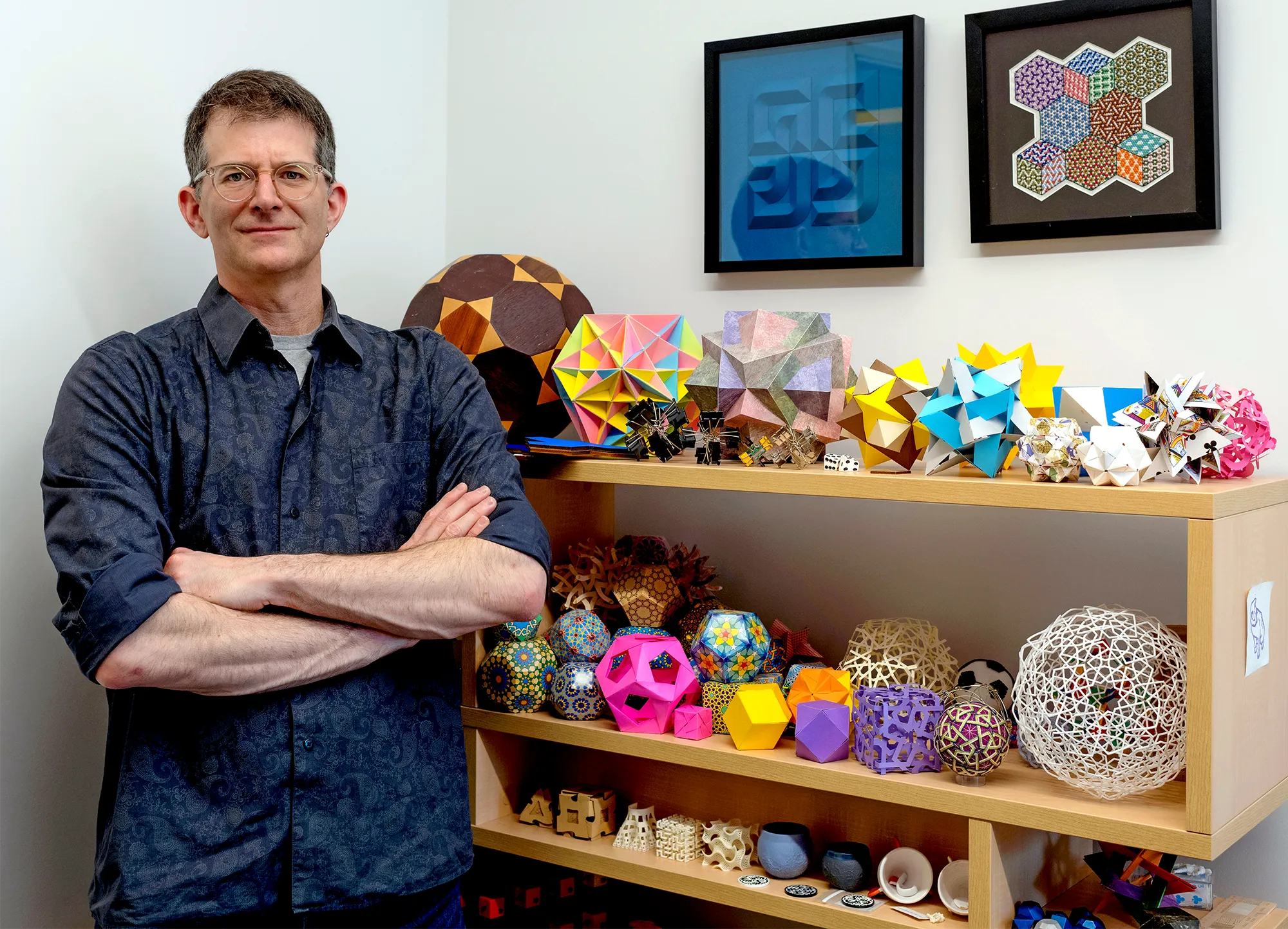 A man standing next to math puzzles.