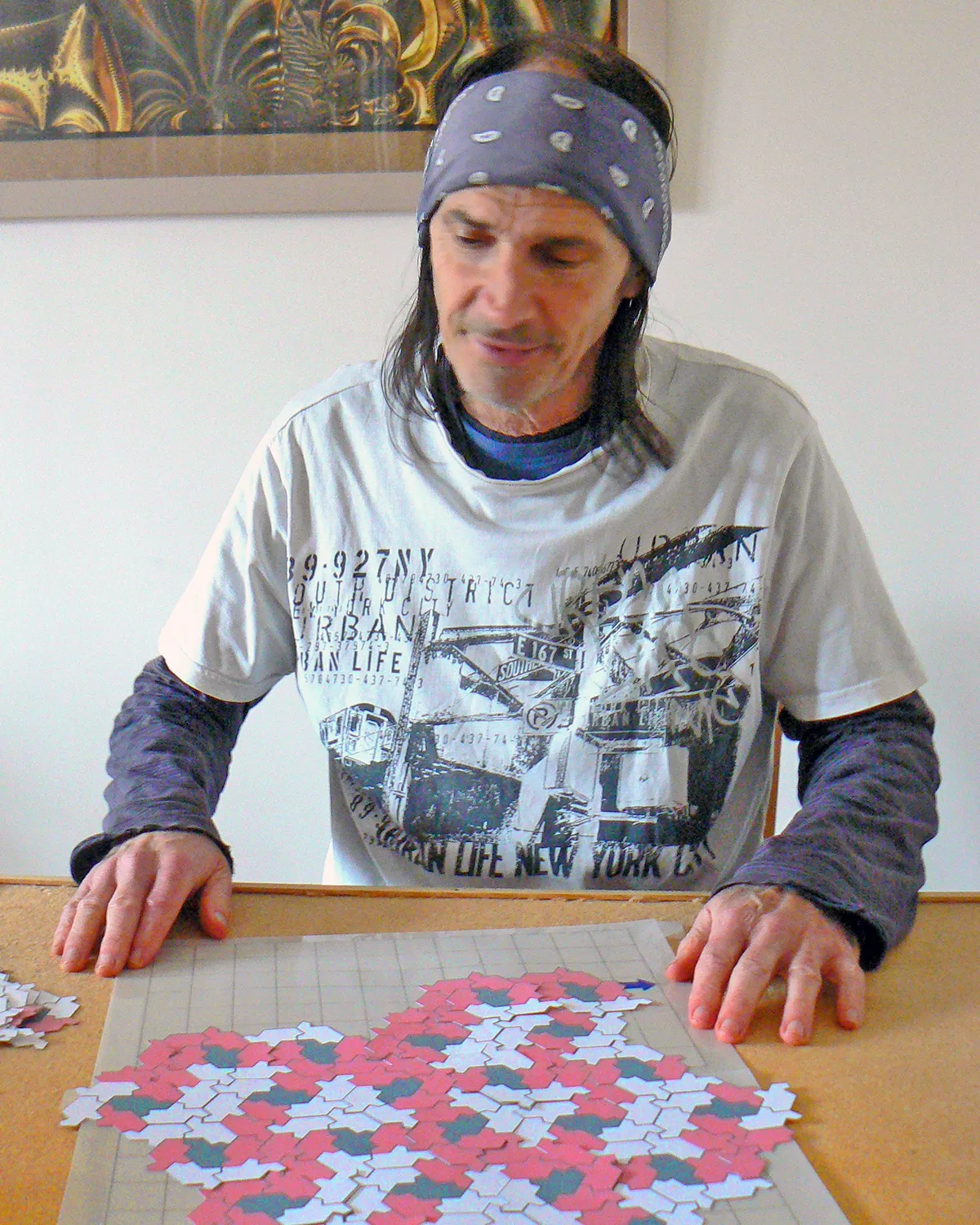 A man playing with what look like puzzle pieces.