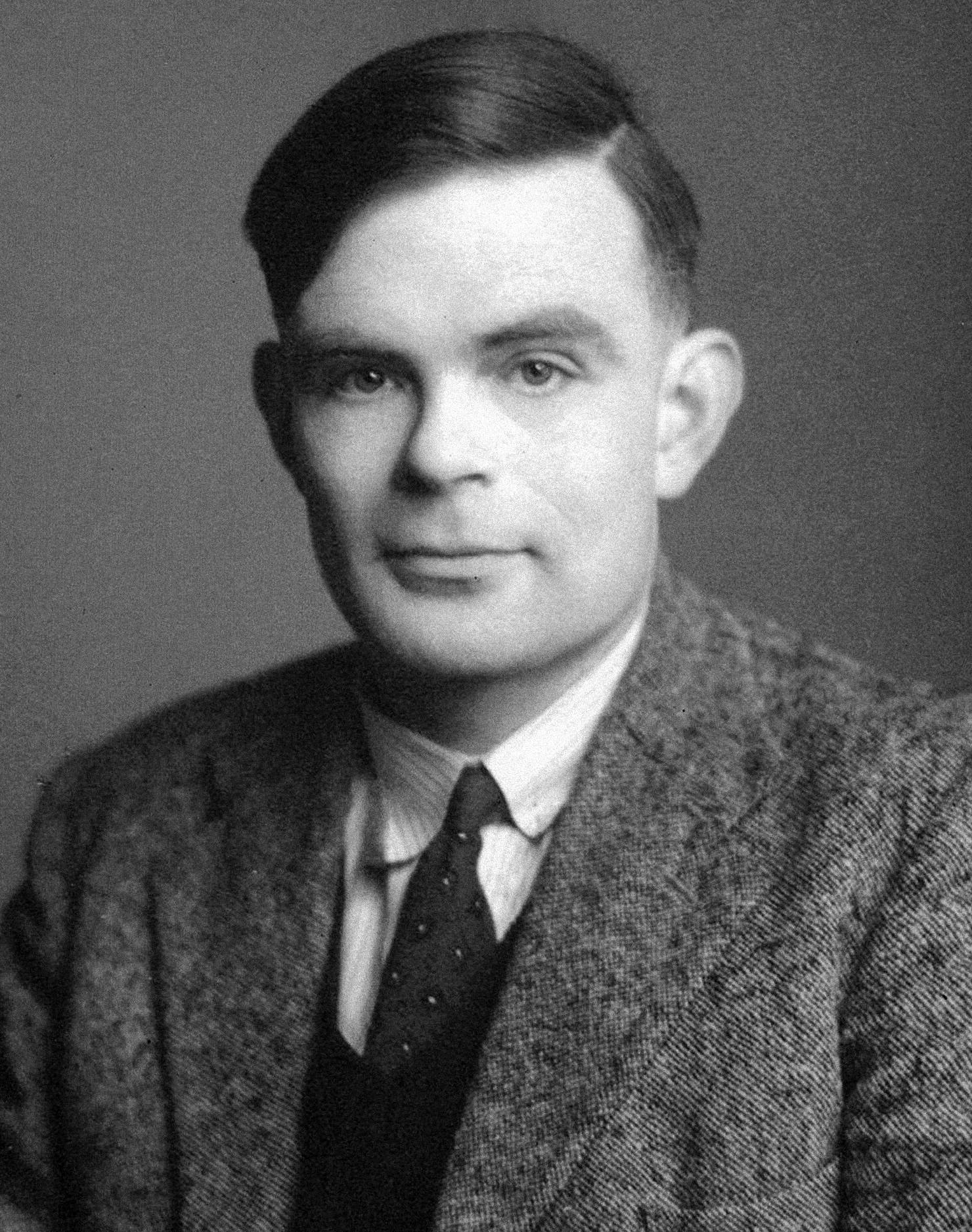 Black and white photo of Alan Turing facing the camera