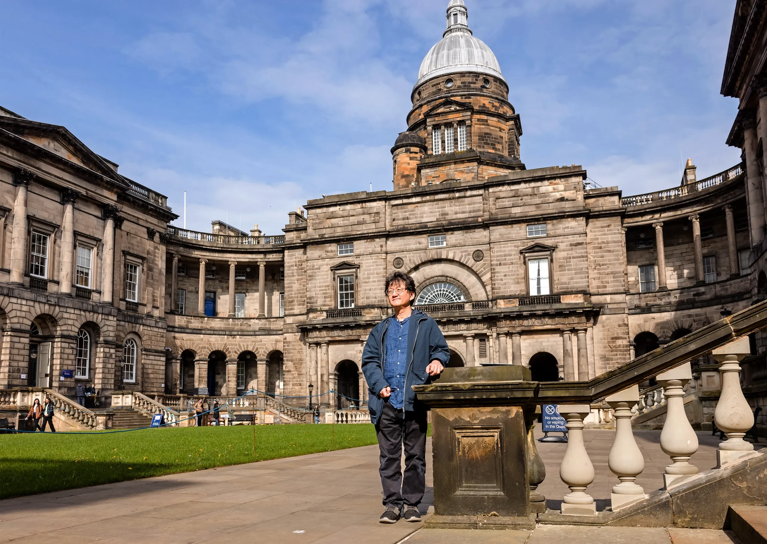 A man standing in a courtyard.