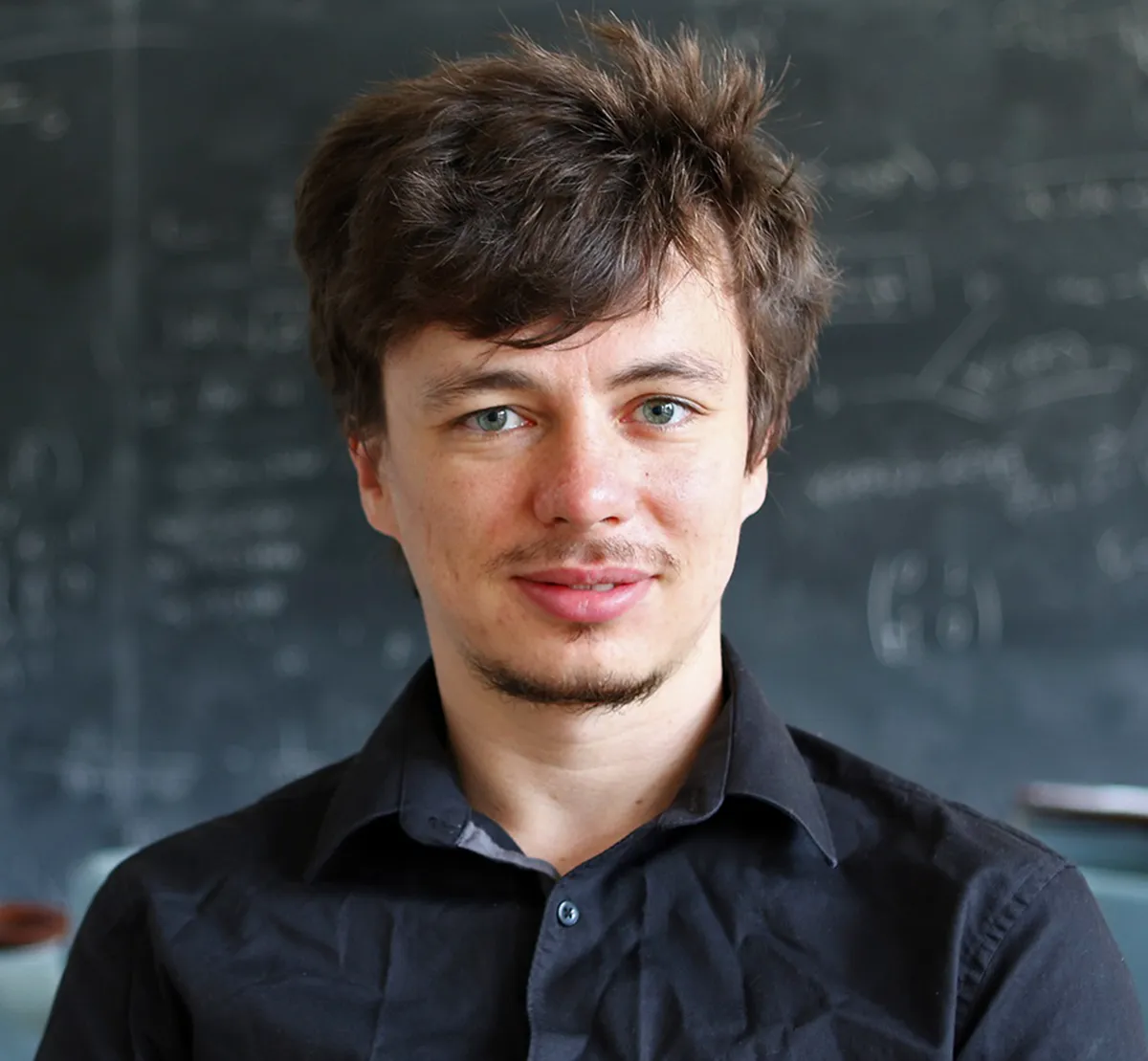 A man with a blackboard in the background.