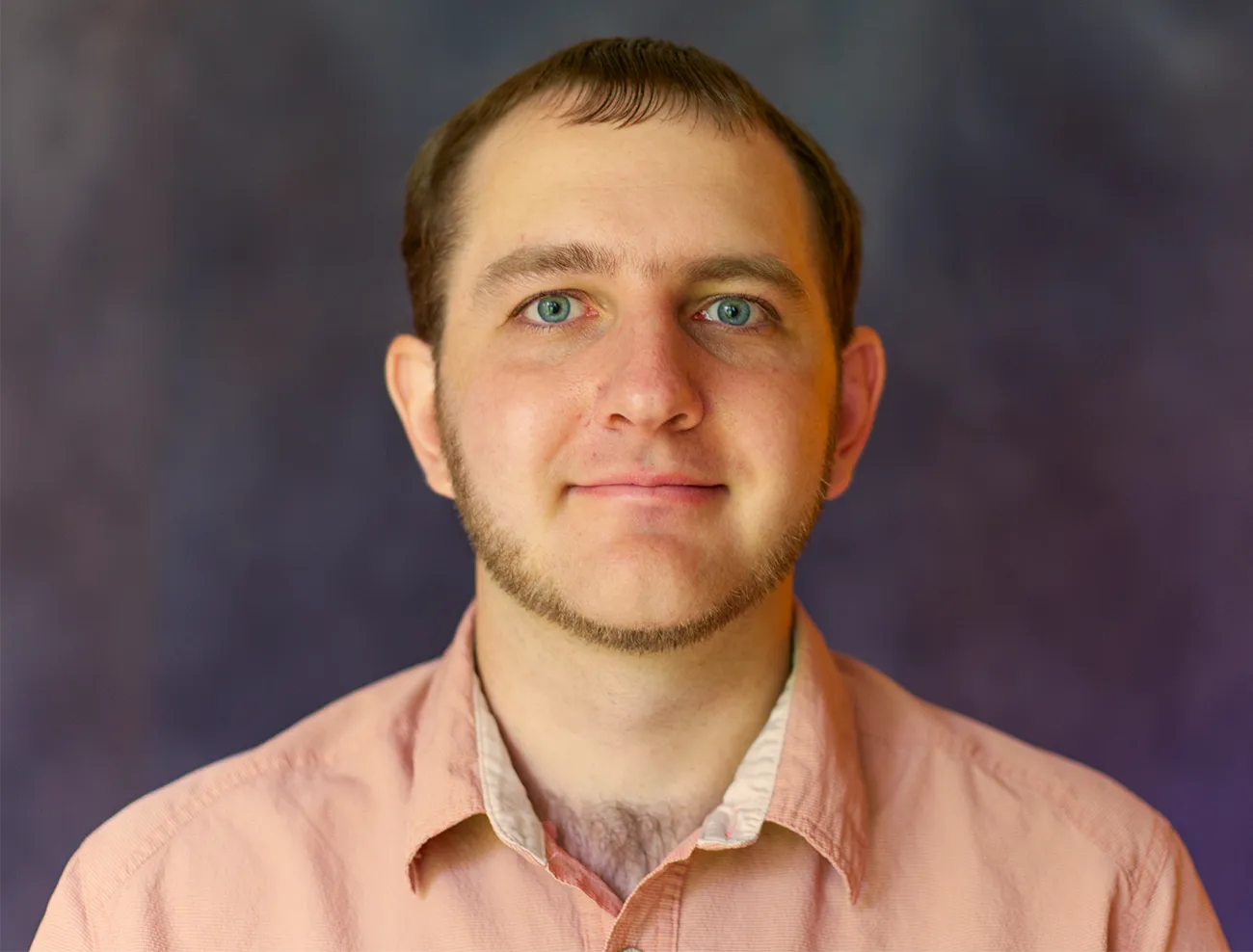 A man in front of a dark background.