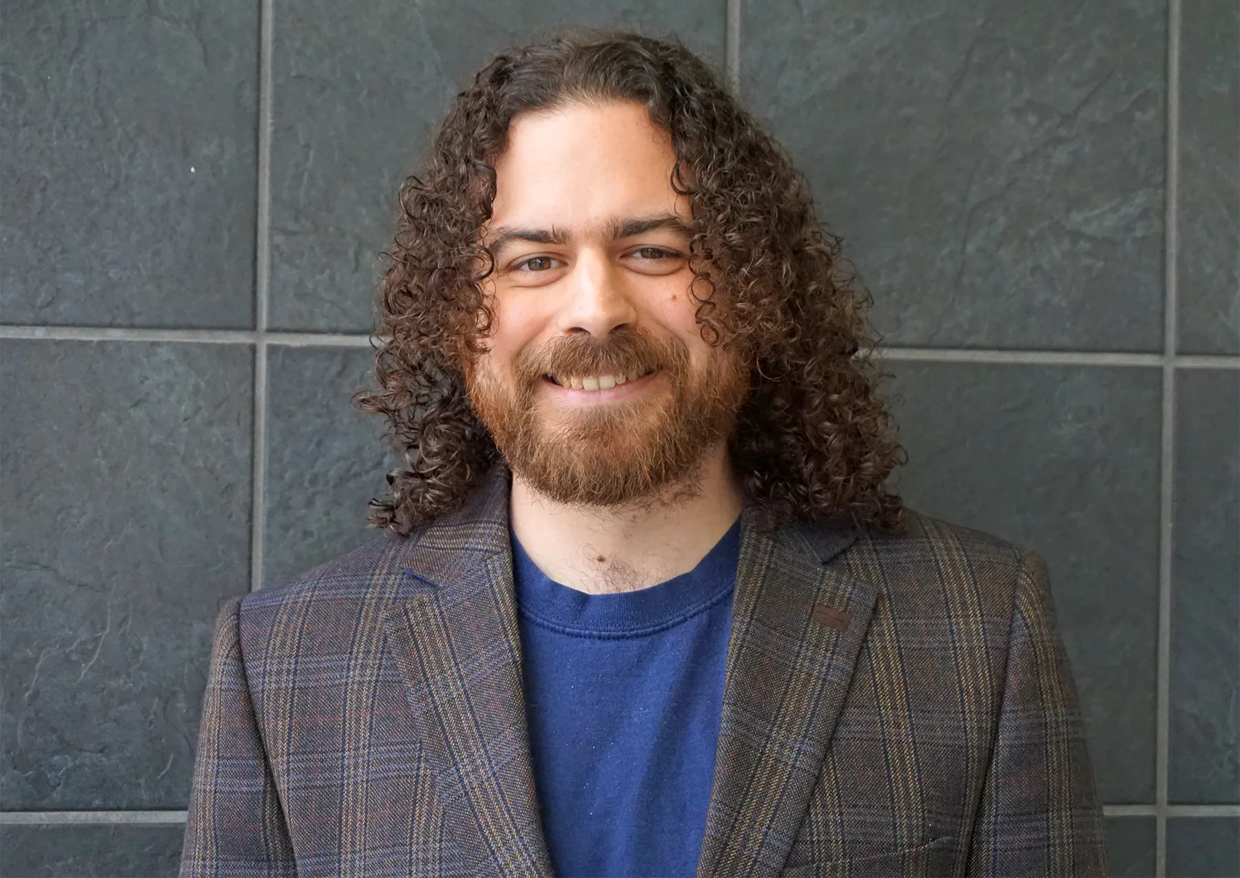 Photograph of Marco Carmosino in a blue shirt and blazer.