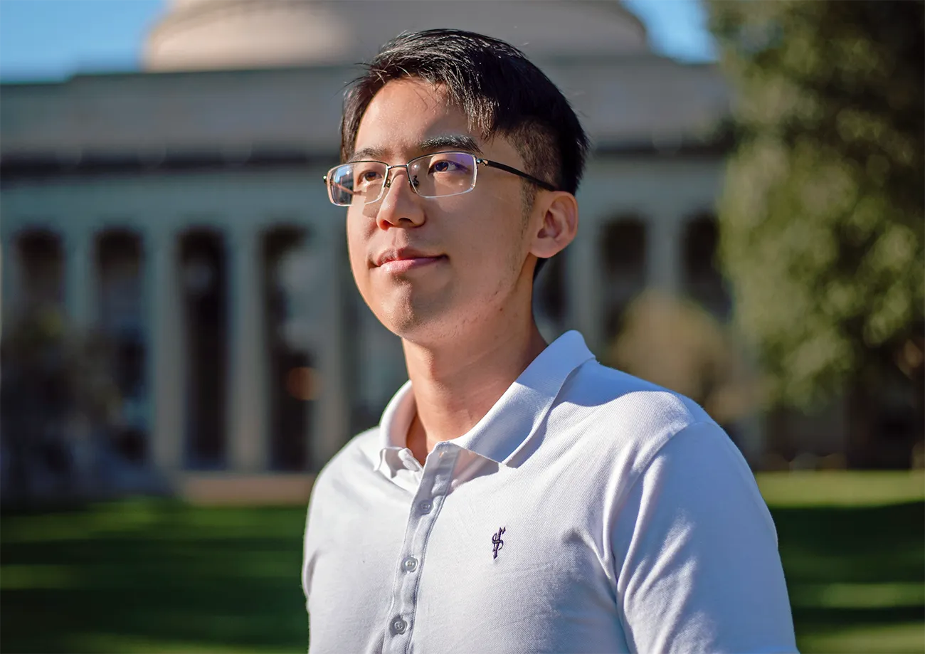 Yilun Xu stands outdoors wearing a white shirt