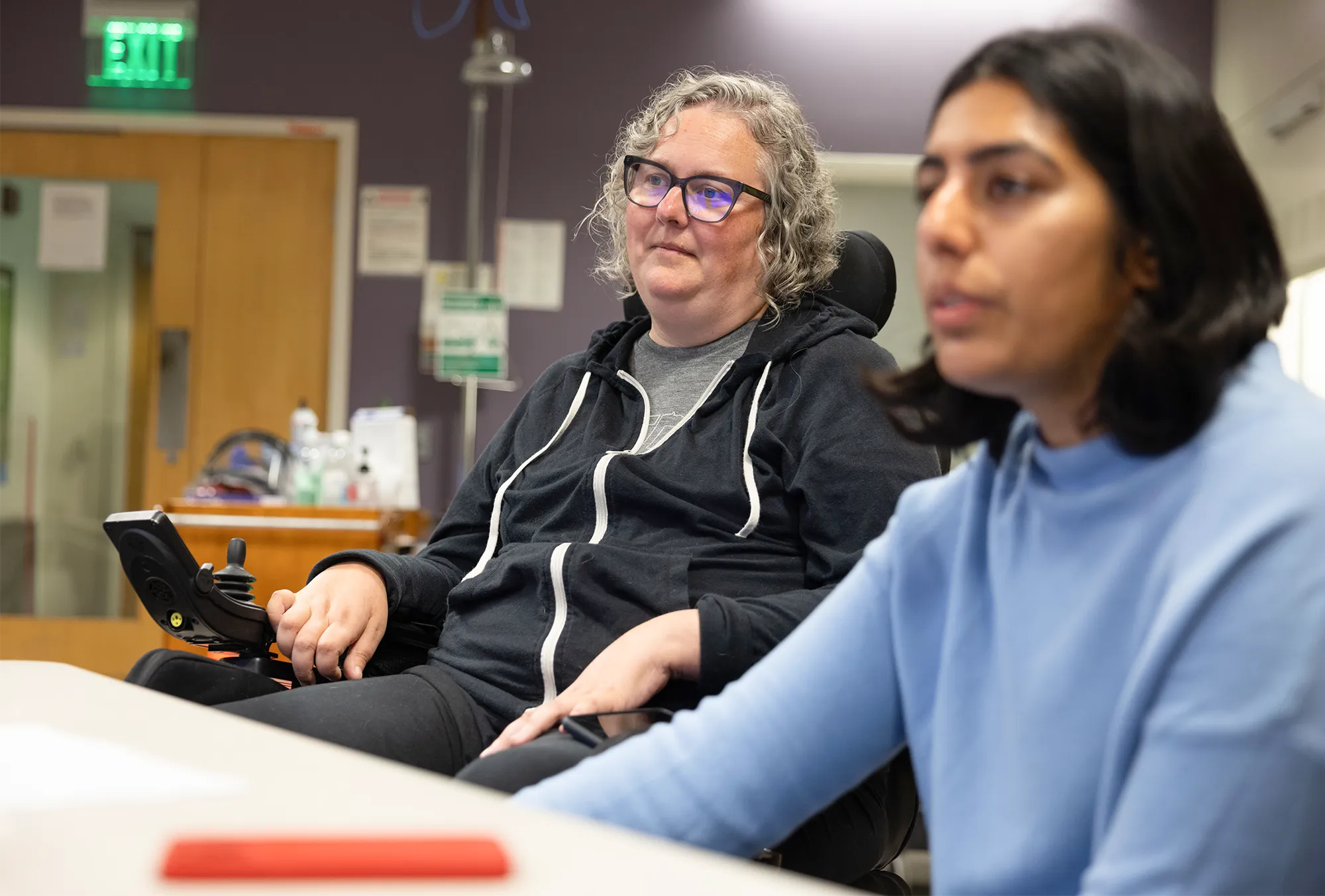 In Carrie Partch’s laboratory, she and her colleague Diksha Sharma look at molecular data displayed on a screen outside the frame of the photo.