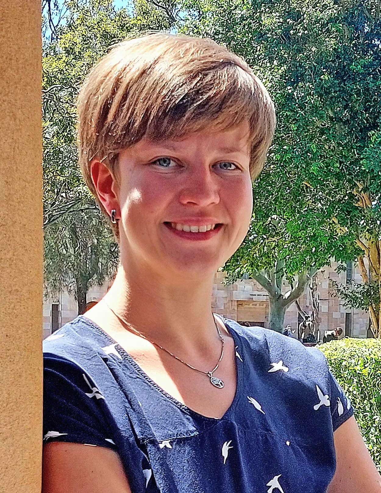 A portrait of Eckert. She is outside, and smiling at the camera.