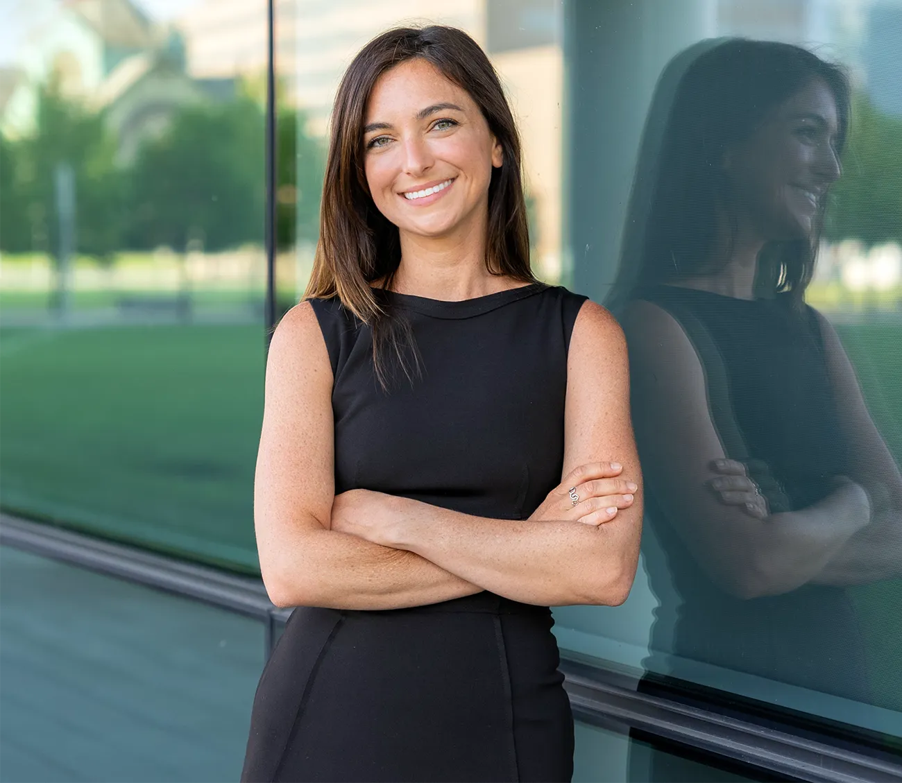 Marissa Scavuzzo poses for the camera in a luxurious glass and stone courtyard.