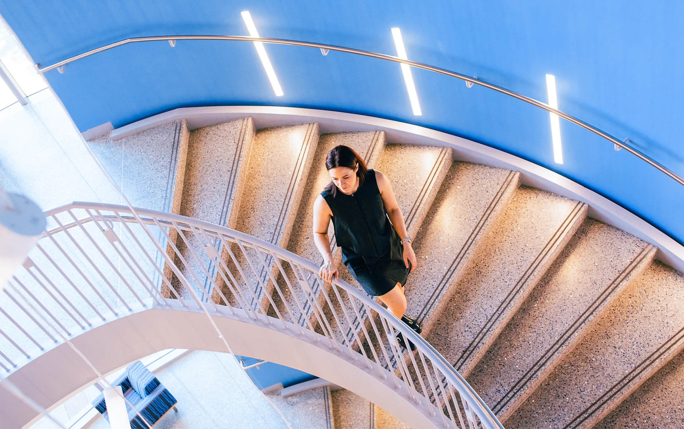 Calipari standing on a spiral staircase.