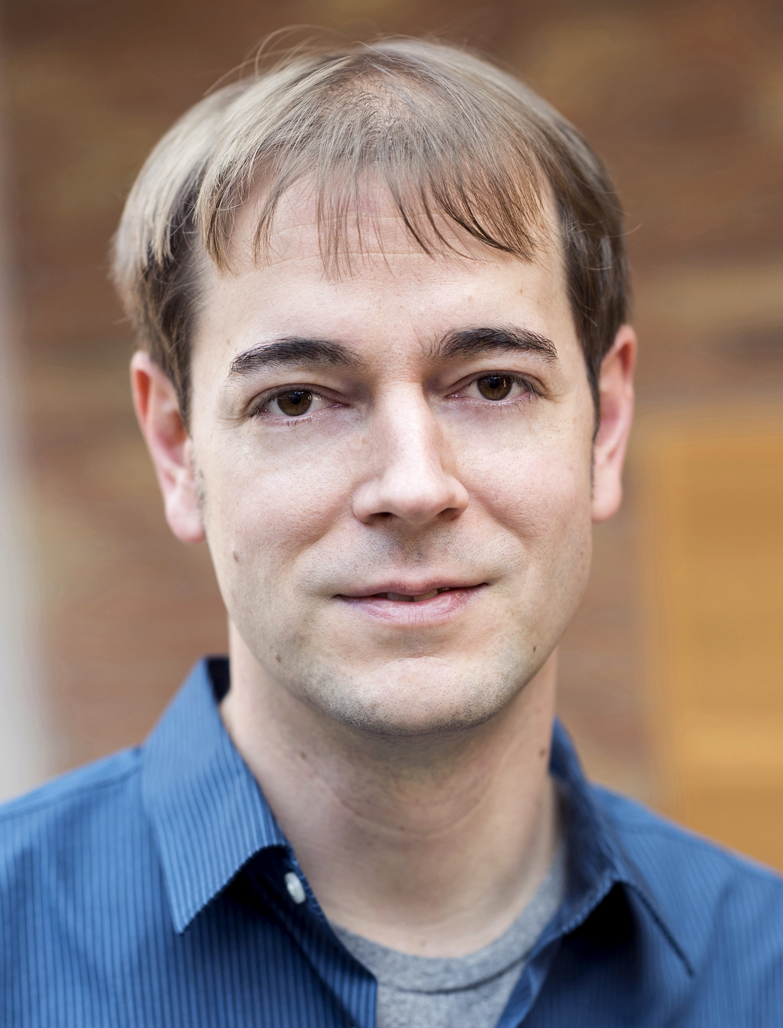 Close up photo of Thomas Rothvoss in a blue striped shirt.