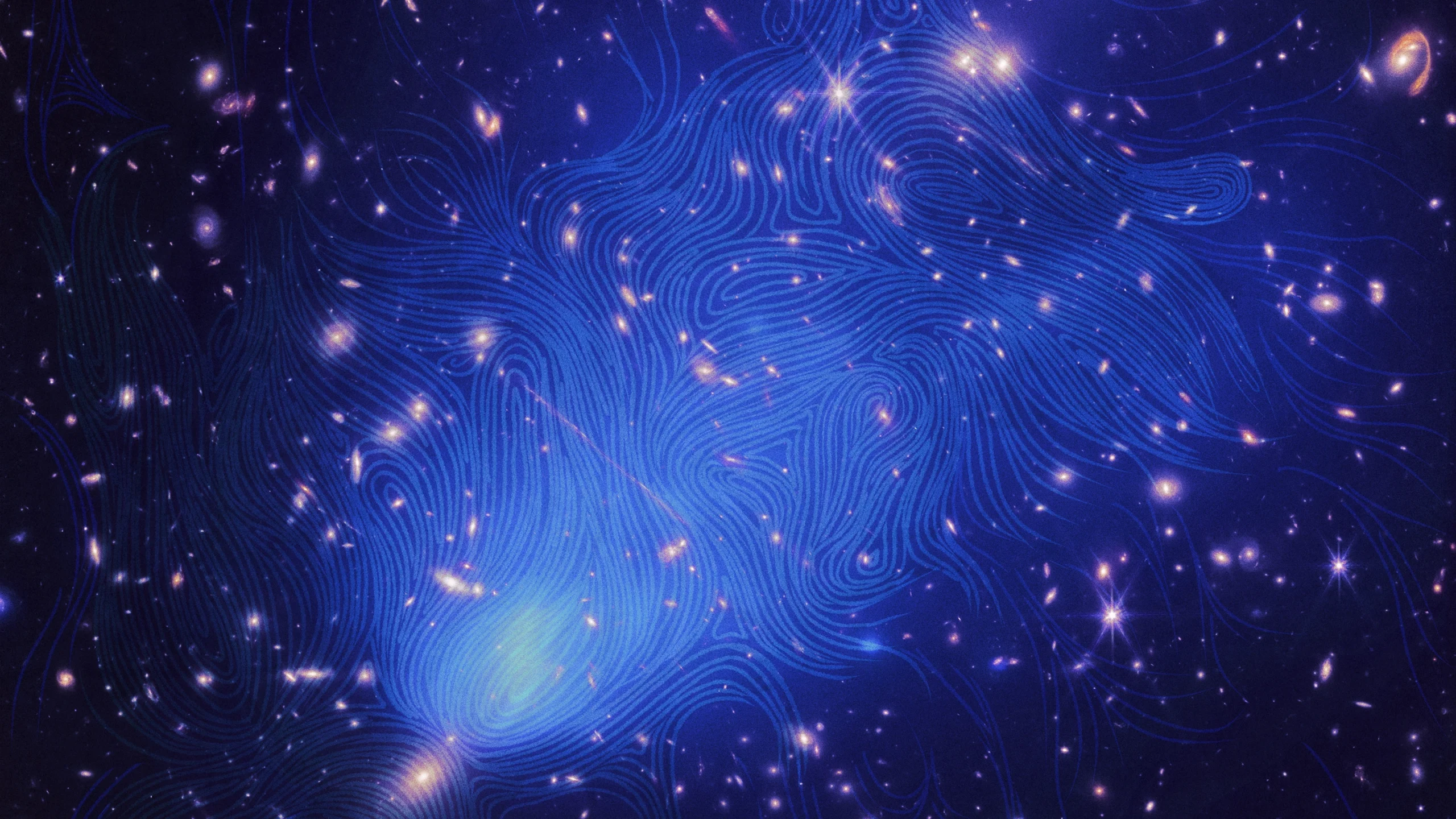 The El Gordo galaxy cluster, which contains hundreds of galaxies, with blue magnetic field lines superimposed on the image. The magnetic field is swirly and resembles a fingerprint.