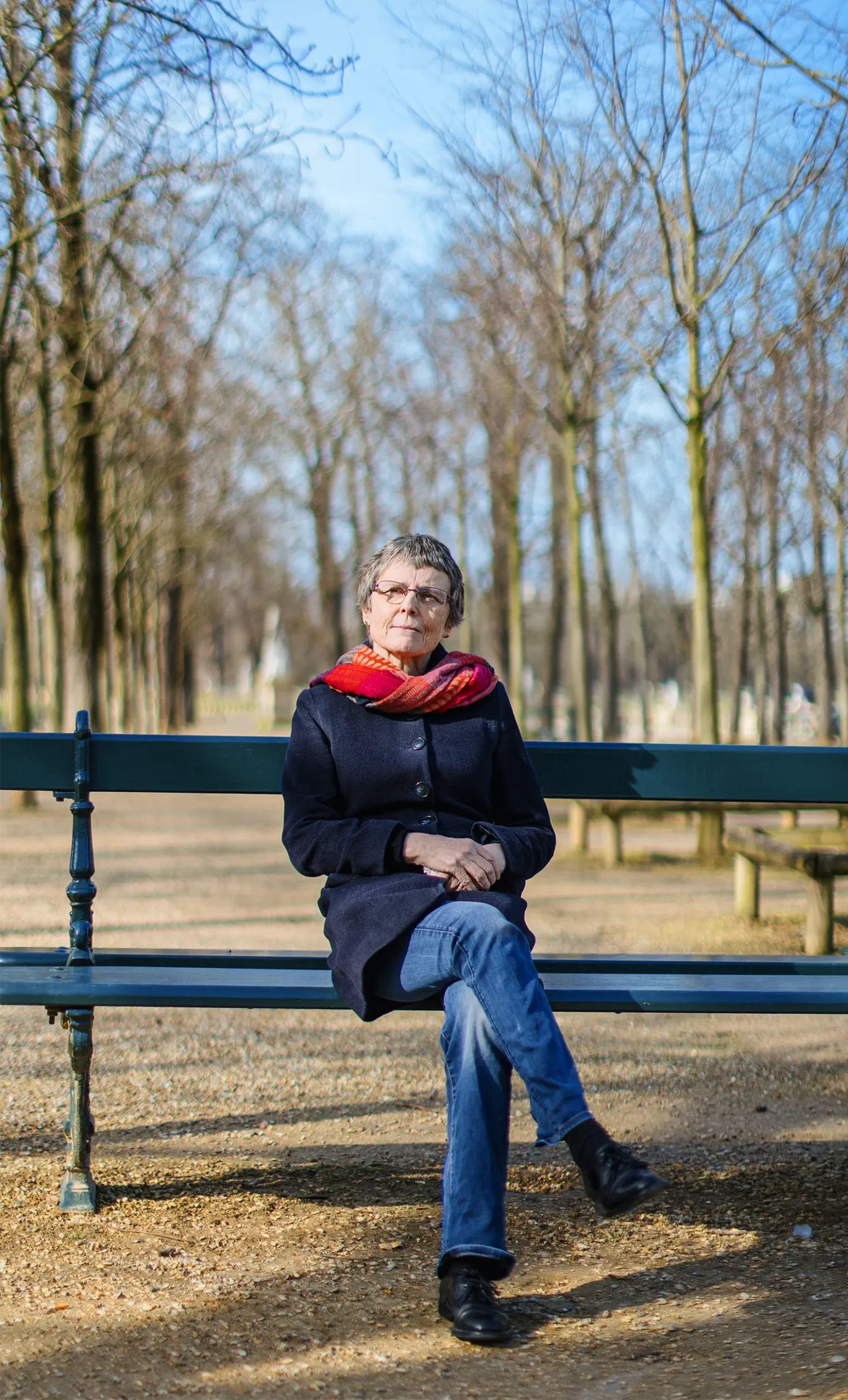 A portrait of Claire Voisin sitting on a bench.