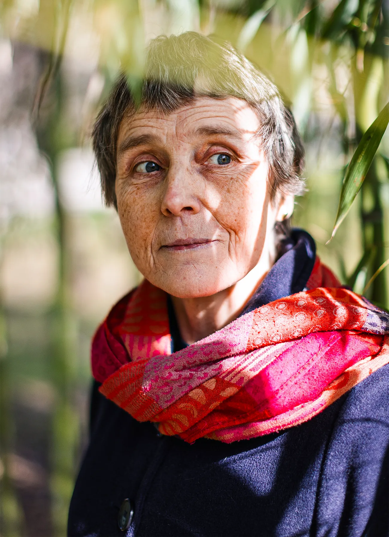 A portrait of Claire Voisin in front of trees.