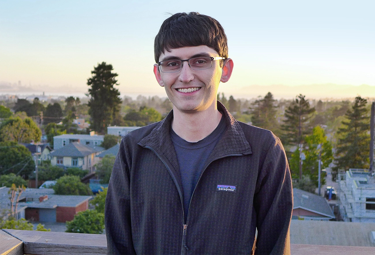 William Kretschmer standing outside in a black sweater.