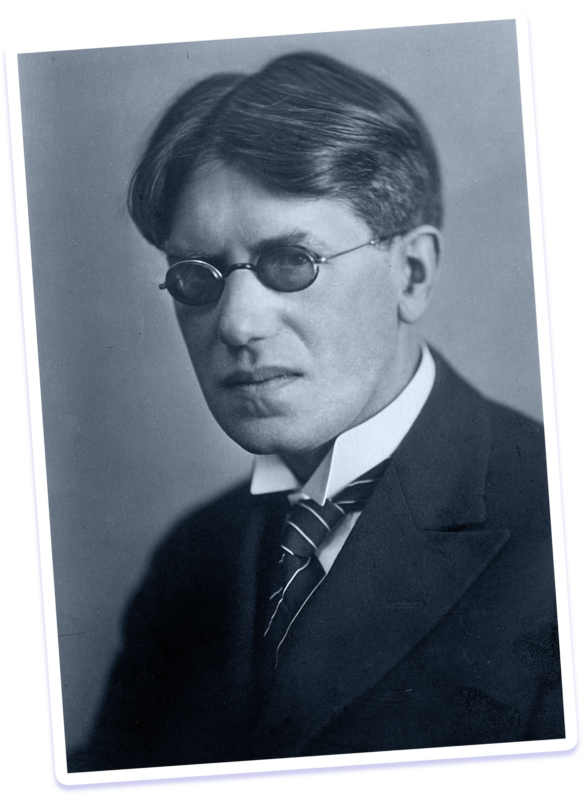 Black-and-white bust portrait of a man with a stern look, shaded eyeglasses, and short hair parted in the center.