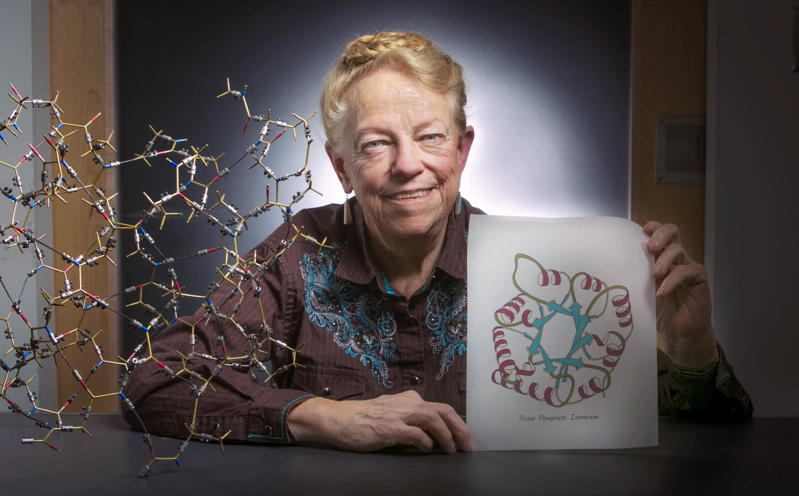 Jane Richardson poses with a model protein and one of her sketches.