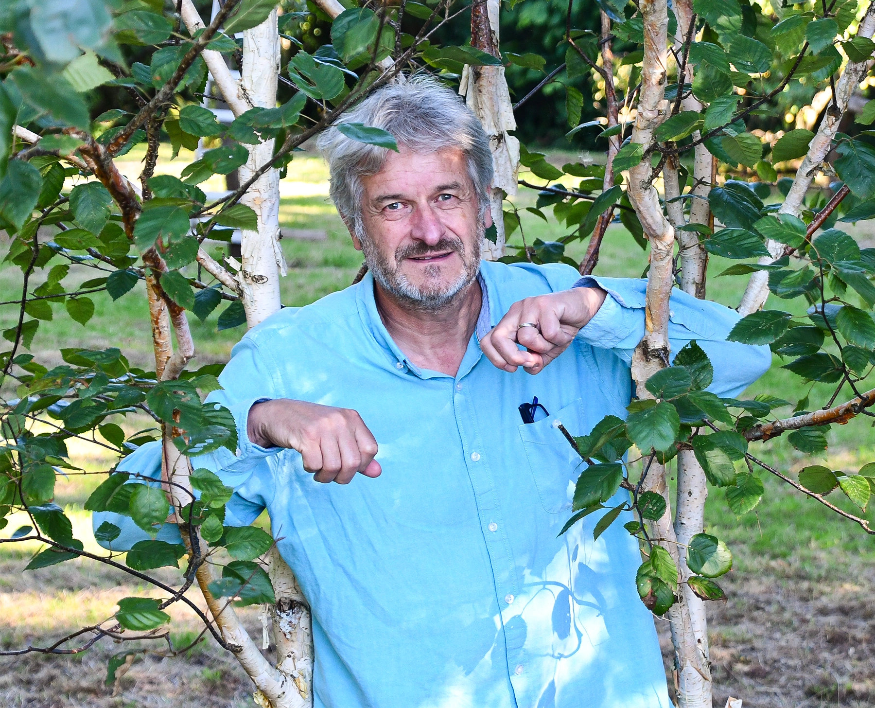 Daniel Robert stands near a tree.